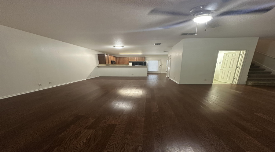 View of half bath, living, dining, and kitchen.