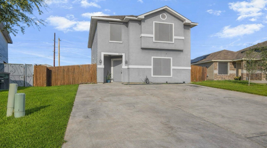 Driveway accommodates up to 6 vehicles.  AI-generated photos for grass placement.